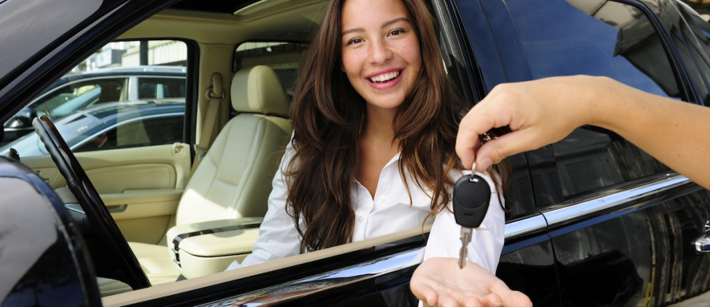 businesswoman receiving keys of her new car
